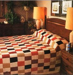 a bed with a checkered bedspread on top of it in a bedroom