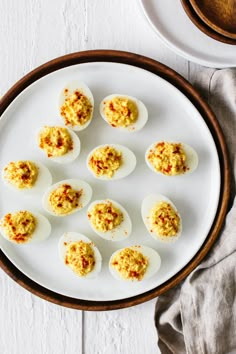 deviled eggs are arranged on a white plate