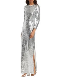 The Markarian Gianna Column gown shines brilliantly with its all-over silvertone sequin embellishments and sophisticated long sleeve design. Crewneck Long sleeves Concealed back zip closure 69% polyester/21% nylon/10% polyester Lining: 100% silk Dry clean Made in USA of Italian fabric SIZE  FIT Model measuremnets: 5'10 tall Model is wearing a US size 4 Long Sleeve Design, Column Gown, Silver Sequin, Italian Fabric, Tall Model, Sleeve Designs, Made In Usa, Embellishments, Fitness Models