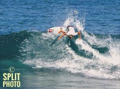 a man riding a wave on top of a white surfboard in the middle of the ocean