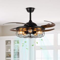 a ceiling fan that is hanging from the ceiling in a room with white walls and windows