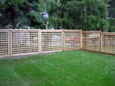 a wooden fence in the middle of a yard