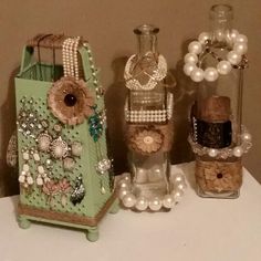 several vases with pearls and other items in them