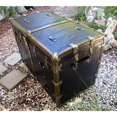 an old trunk is sitting on the ground