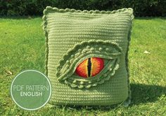 a crocheted pillow with an eye on it