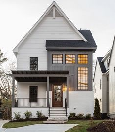 a white two story house with black shutters