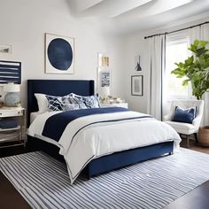 a bedroom with blue and white bedding, striped rugs and artwork on the wall