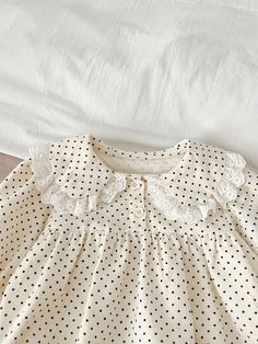 This cotton print romper is a must-have for any baby's wardrobe. With long sleeves and a ruffled collar, it provides both warmth and style. The polka dot pattern adds a touch of cuteness, making it perfect for any occasion. Give your little one the ultimate comfort and fashion with this adorable baby romper. Polka Dot Long Sleeve Cotton Dress, Long Sleeve Polka Dot Cotton Dress, Body Blouse, Blouse Necklines, Ruffled Collar, Printed Rompers, Adorable Baby, Polka Dot Pattern, Peter Pan Collar