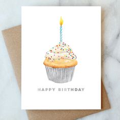 a birthday card with a cupcake on it and a lit candle in the middle