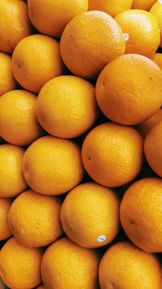 a pile of oranges sitting on top of each other