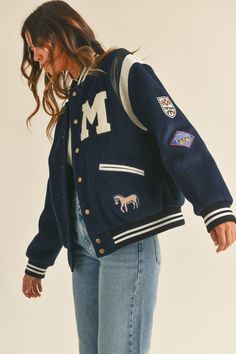 Stay warm and stylish in this M Bomber Varsity Jacket. Crafted with a long sleeve fit, this jacket features cute patches and embroidery detail for a unique look. The quilted inside adds an extra level of warmth and comfort, while the premium quality ensures it stands the test of time Jersey Jacket Outfit, Varsity Jacket Outfit Women, Varsity Outfit, Senior Jackets, Varsity Jacket Outfit, Vintage Varsity Jacket, Varsity Jacket Women, Jacket Outfit Women, College Jackets