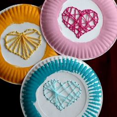 three paper plates with hearts on them and one is made out of yarn, the other has string