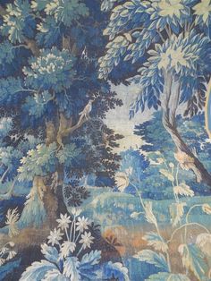 a blue and white wallpaper with trees and flowers on it's side, next to a clock