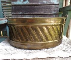 an old metal tub sitting on top of a table