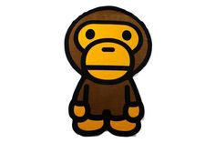 a brown and black monkey sticker sitting on top of a white wall