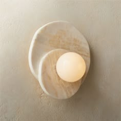 Two round pieces of natural cream onyx layer organically in this Nicholas Obeid design. Soft and sculptural with a single opaque white glass globe, wall sconce hangs like a piece of art. Learn about Nicholas Obeid on our blog. CB2 exclusive.  -Designed by Nicholas Obeid -Natural cream onyx with opaque white glass globe -Each will be unique -Accommodates one 5W max G9 bulbs not included -Dimmable bulb recommended for use with dimmer switch -Hardwired fixture; professional installation recommended Onyx Wall, Bathroom Sconces, White Onyx, Jw Marriott, Modern Wall Sconces, White Concrete, Style Deco, Marble Wall, Natural Cream