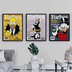 three cartoon posters hang on the wall in a living room