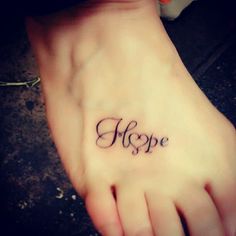 a woman's foot with the word hope tattooed on it