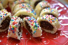 a white plate topped with donuts covered in frosting and sprinkles