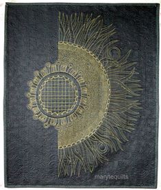 a black and gold wall hanging with an intricate design