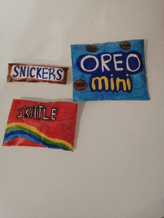 some candy stickers are on top of a refrigerator door that is decorated with the word oreo and skittle