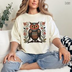 Embrace the cozy charm of boho style with our t-shirt featuring an enchanting owl surrounded by vibrant, whimsical flowers. Designed in a rich palette of colors, this cottagecore-inspired tee captures a nature-loving, free-spirited aesthetic perfect for adding a touch of bohemian magic to your wardrobe. 🐘THESE SHIRTS RUN LARGE - Please refer to the size chart before ordering 💰Exchanges and Returns accepted ™️Comfort Colors - High Quality 100% Cotton Unisex Garment-dyed Medium Weight Tees 👀Images are an accurate depiction of what you'll receive upon purchase 👣Printing is "Direct To Garment"  (Ink printed). 📏Size Chart - Please see image 🌳100% Ring-spun Cotton 🪨Mid-weight Material 🚻Unisex Sizing - Relaxed Fit 📦Free Shipping in the US 💦Machine-wash cold inside out.  Tumble dry low ? Free Spirit Aesthetic, Floral Tshirt, Whimsical Flowers, Owl Shirt, Bird Shirt, Nature Shirts, Comfort Colors Tee, Flower Shirt, Free Spirited