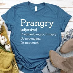 a blue t - shirt with the words prangry on it next to some cotton