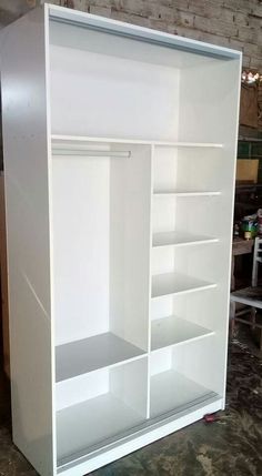 a large white bookcase with shelves in the middle