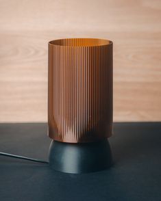 a brown vase sitting on top of a black table