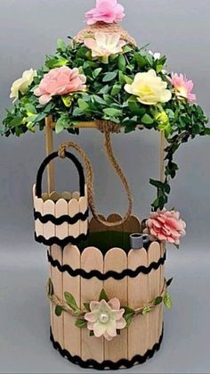 a wooden basket with flowers on it and the words how to make a flower pot out of cardboard