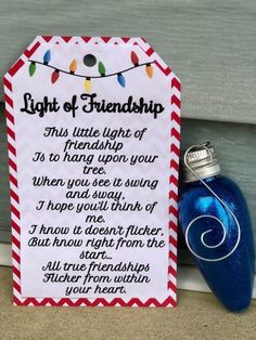 a blue bottle next to a sign that says, light of friendship this unique light of friendship is to hang upon your door