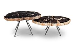 two wooden tables with metal legs and black marble on the top, one is made from wood