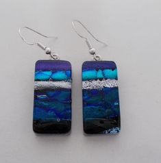 I fused 2 layers of glass to create this gorgeous earring ,,dichroic glass and clear glass on the top. The size is 1/2" by 1 " .All my jewelry come in a nice gift box. Silver Czech Glass Earrings As Gift, Silver Czech Glass Earrings For Gift, Rectangular Czech Glass Earrings For Gifts, Clear Glass Earrings As A Gift, Iridescent Ear Wire Earrings For Gift, Clear Glass Earrings For Gifts, Clear Glass Earrings For Gift, Czech Glass Rectangular Earrings For Gift, Iridescent Czech Glass Jewelry For Gift