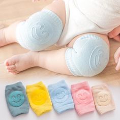 a baby laying on the floor with five pairs of diapers