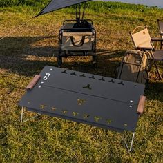 an outdoor table and chair set up in the grass