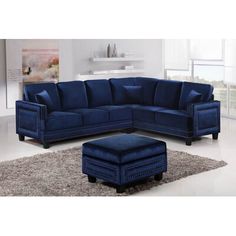 a blue sectional couch sitting on top of a rug