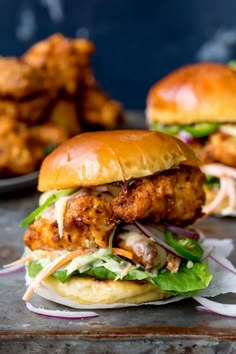 two chicken burgers with lettuce and onions