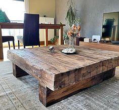 a wooden table sitting in the middle of a living room