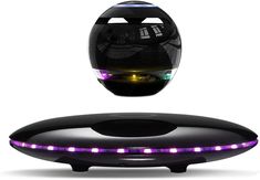 a black object with purple lights on it's side and the light reflecting off its surface