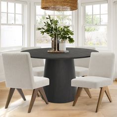 a round table with four chairs around it and a potted plant in the center