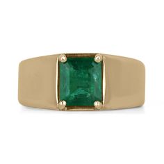 a gold ring with an emerald stone in the center