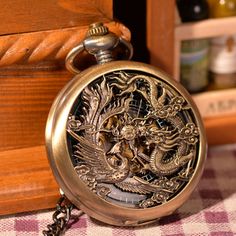 Introducing the "Hollow Dragon and Phoenix Play Beads Pocket Watch," an antique style pocket watch that will be the perfect gift for her or him. This unique pocket watch is sure to be the perfect statement piece, making it a great gift for pocket watch lovers and collectors. The hollow dragon and phoenix play beads adds more character to the piece and elevates it to another level. It comes with a special pocket watch chain, making it easy to carry around.The pocket watch combines Gothic and stea Necklace Clock, Skeleton Pocket Watch, Steampunk Pocket Watch, Phoenix Pendant, Vintage Skeleton, Dragon Phoenix, Flying Dragon, Unique Pockets, Mechanical Pocket Watch