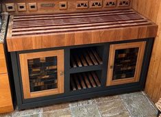 a kitchen with wooden cabinets and tile flooring on the counter top, next to an oven