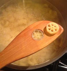 a wooden spoon in a pot filled with water