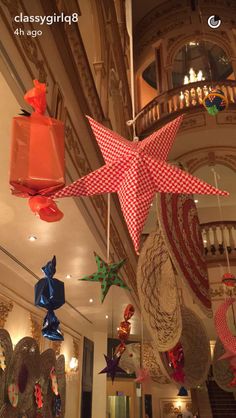 some paper stars hanging from the ceiling in a building