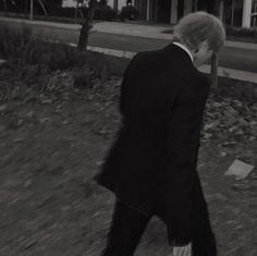 a man in a suit walking down the street