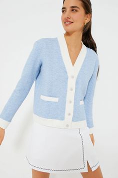 a woman wearing a blue and white cardigan sweater