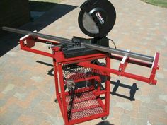 a red cart with a circular object on it