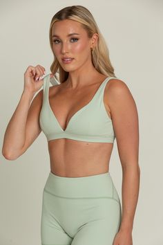 Our Pastel Green Bralette will be your go-to for everyday comfort. This plunging V-cut neckline bralette features removable padding for customizable support and is hardware-free for a seamless fit. Crafted from buttery soft fabric, it offers a luxurious feel against your skin. Perfect for lounging or layering, this comfortable and stylish bralette will quickly become a staple in your wardrobe. Solid Color Low-cut Sports Bra With Removable Pads, Chic Sports Bra With Built-in Bra For Workout, Chic Workout Sports Bra With Built-in Bra, Summer Seamless Triangle Top Nursing Bra, Seamless Triangle Top Nursing Bra For Summer, Chic Seamless Low-cut Bra, Triangle Top Sports Bra With Removable Pads, Seamless Triangle Top Sports Bra, Seamless Triangle Top Sports Bra In Solid Color