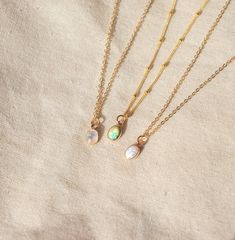 Our Dainty gemstone necklace features a tiny little stone, choose between opal, moonstone and turquoise. DETAILSGOLD VERSION:•PENDANT is Genuine Turquoise, Genuine Moonstone, or Synthetic Opal, measuring 5 x 7mm•CHAIN is 14k Gold Filled•CLASP is 14k Gold Filled Matching ………………………………….PERSONALIZE IT! ADD A STAR INITIAL CHARM:https://www.etsy.com/ca/listing/627638174/add-a-star-initial-charmADD A STAMPED INITIAL:https://www.etsy.com/ca/listing/561708083/add-an-initialADD A BIRTHSTONE:https://www.e Delicate Moonstone Necklace With Delicate Chain, Dainty Adjustable Opal Necklace, Dainty Opal Adjustable Necklace, Dainty Adjustable Moonstone Necklace, Dainty Moonstone Teardrop Pendant Necklace, Dainty Moonstone Charm Necklace For Gift, Dainty Oval Adjustable Necklace, Dainty Everyday Necklaces With Natural Stones, Delicate Moonstone Round Pendant Necklace